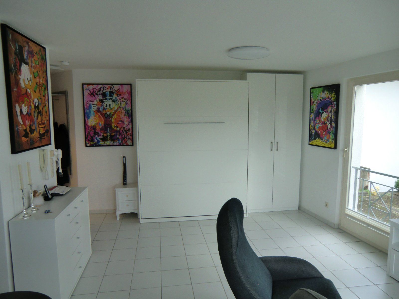 Zimmer mit modernen Kunstwerken und geschlossenem Schrankbett